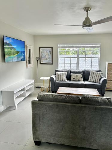 a living room with a couch and a table at Perfect remote work spot! Close to everything! in West Palm Beach