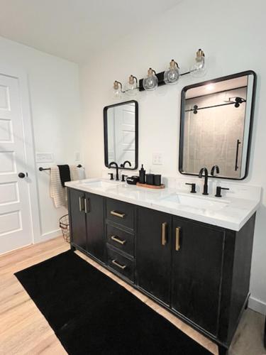 a bathroom with a sink and a mirror at Love Shack in Foley/ Hot Tub / Modern Cozy in Foley