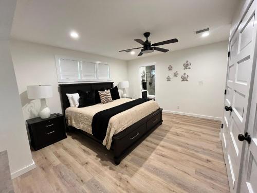 a bedroom with a bed and a ceiling fan at Love Shack in Foley/ Hot Tub / Modern Cozy in Foley
