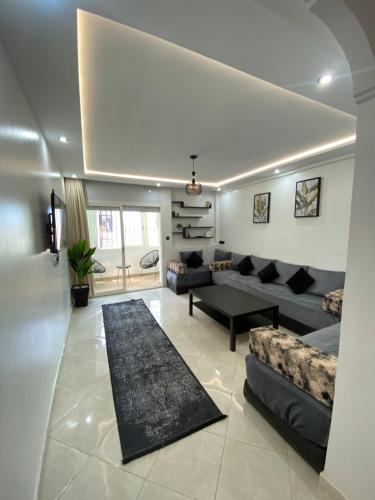 a living room with a couch and a table at Lovely 2 bedroom apartment in Rabat