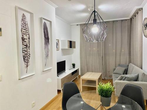 a living room with a table and a couch at Valleca Tren Sierra Guadalupe 2 in Madrid