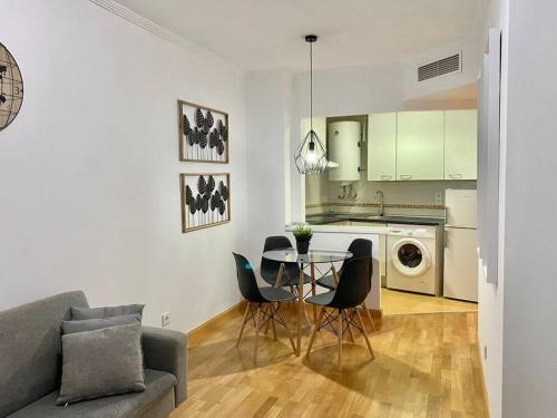 a kitchen and living room with a table and chairs at Valleca Tren Sierra Guadalupe 2 in Madrid