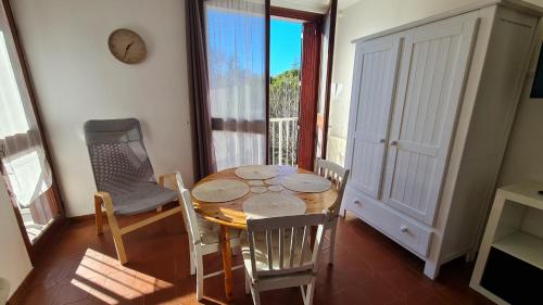 une salle à manger avec une table et des chaises et une fenêtre dans l'établissement Superbes studios du Parc Paradis, à Gréoux-les-Bains