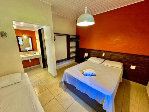 a hotel room with a bed and a sink at Porto Grande Hotel & Convention in São Sebastião