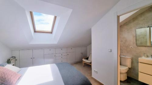 a bedroom with a white bed and a window at El Rincon de las Americas in Colombres