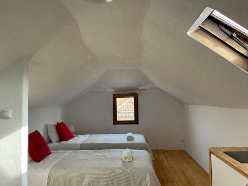 a bedroom with two beds in a attic at Casa do Cristo Rei I in Almada