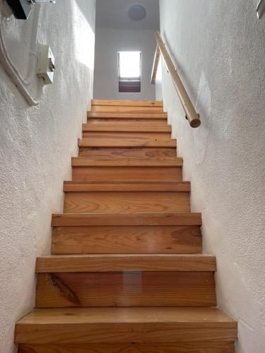 a stairway with wooden stairs in a house at Casa do Cristo Rei I in Almada
