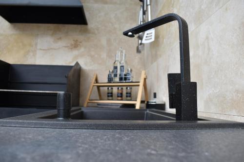 a kitchen sink with a faucet on a counter at Woodpecker in Nagymaros