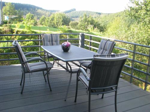 a table and four chairs on a deck at Holiday Home Pandora in Bouillon