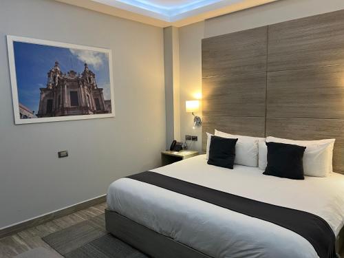 a bedroom with a large bed in a hotel room at Hotel GRALTA in Jalostotitlán