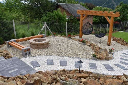 a garden with a playground and a swing at Woodpecker in Nagymaros