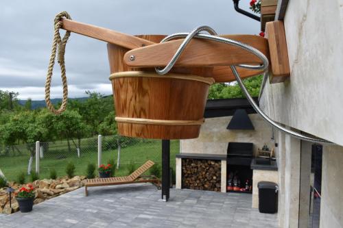 a large wooden pot hanging from the side of a building at Woodpecker in Nagymaros