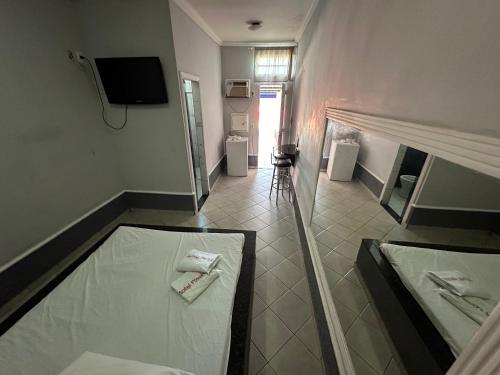 een badkamer met 2 handdoeken op de vloer bij Motel Power in Belo Horizonte
