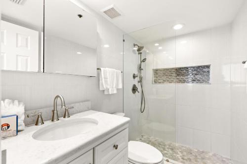 a white bathroom with a sink and a shower at One Seagrove Place 1606 in Santa Rosa Beach