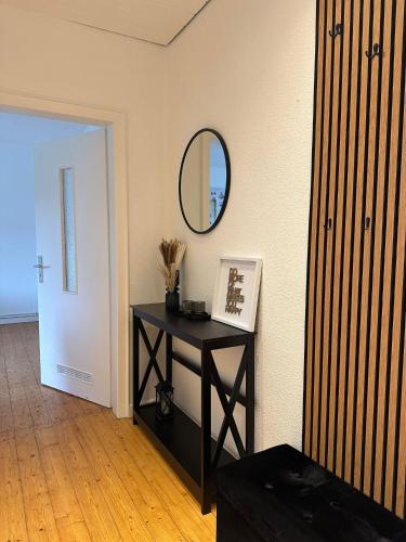 a room with a black table and a mirror at Top Ferienwohnung 55qm, Netflix, Prime in Bochum