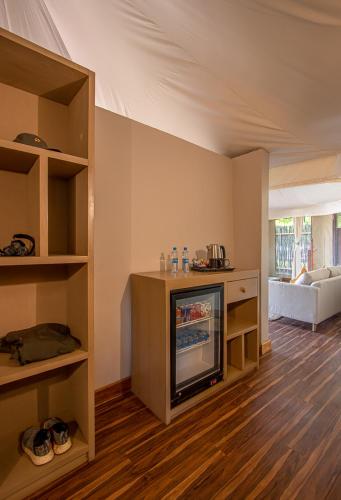 a living room with a fireplace in a room at Mopani Safari Lodge in Mfuwe