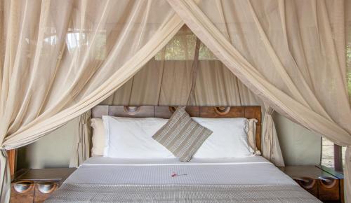 A bed or beds in a room at Mopani Safari Lodge