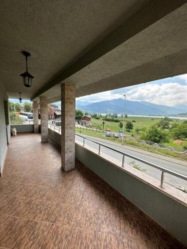 a room with a balcony with a view of a highway at Lake River Mountain in Plav