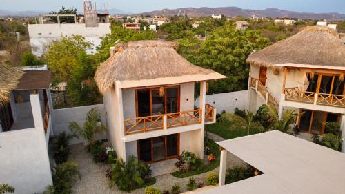 an aerial view of a house with a thatched roof at Casa Mochila in Malucano