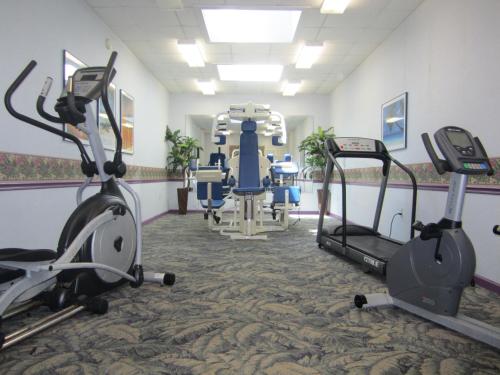 a gym with cardio equipment and tread machines at Sun Viking Lodge - Daytona Beach in Daytona Beach