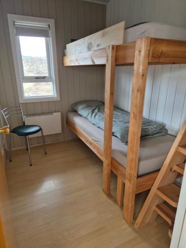 Łóżko piętrowe w niewielkim pokoju z oknem w obiekcie Eaglerock guesthouse 2 w mieście Kirkjubæjarklaustur