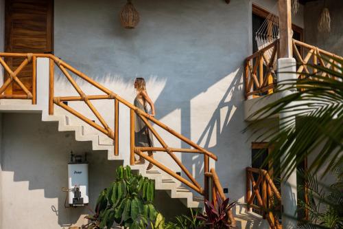 a woman walking down the stairs of a house at Casa Mochila in Malucano