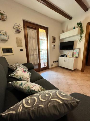 a living room with a couch and a tv at Casa L ulivo in Santa Maria Navarrese