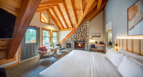 a bedroom with a large bed and a fireplace at Buffalo Mountain Lodge in Banff