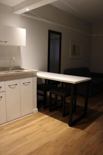 a kitchen with a table and a counter top at Ninety Hotel in Sao Paulo
