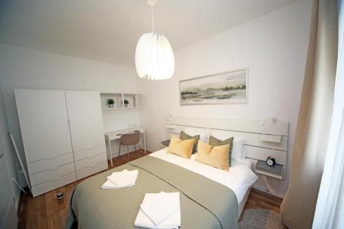 a bedroom with a large bed with yellow pillows at Apartment Fala - self check-in 0-24, fast wi fi, city center in Zagreb