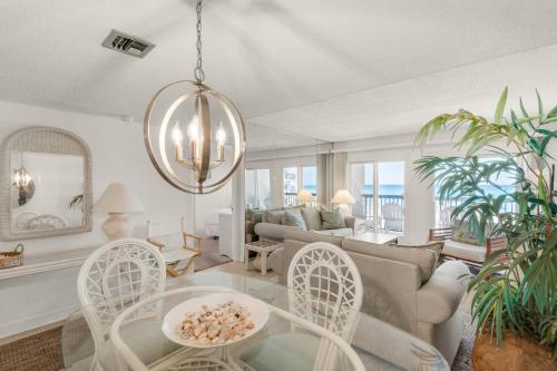 a living room with a couch and a table and chairs at Pinnacle Port C1-203 in Carillon Beach