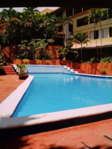 a large blue swimming pool in a building at Sosua Best Condos in Sosúa