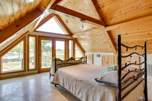 a bedroom with a bed in a wooden house at Hornersville Vacation Rental with Private Pond! 