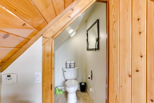 a bathroom with a toilet and a wooden ceiling at Hornersville Vacation Rental with Private Pond! in Hornersville