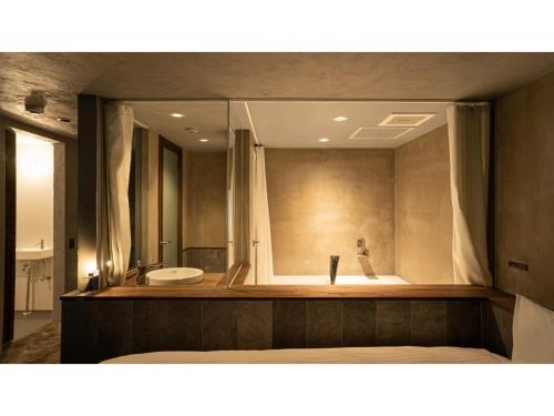 a large bathroom with a tub and a sink at Hotel Discover Nagaokakyo - Vacation STAY 34376v in Nagaokakyo