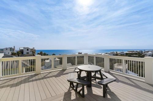 a deck with a table and two chairs on a balcony at A Point of View in Seagrove Beach