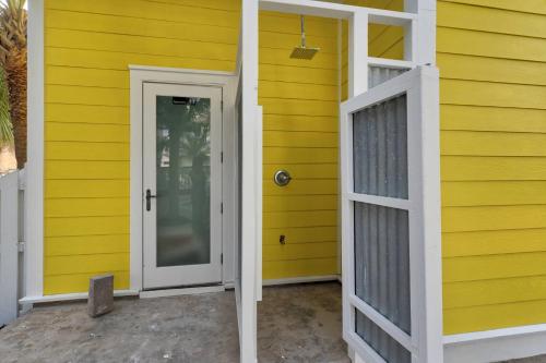 a yellow house with a door and a window at A Point of View in Seagrove Beach