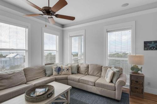 a living room with a couch and a ceiling fan at A Point of View in Seagrove Beach