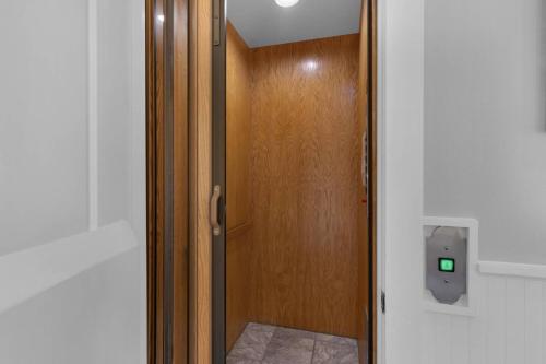 a wooden door with a green light on it at A Point of View in Seagrove Beach