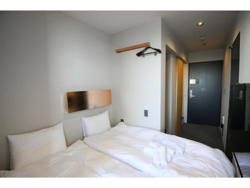 a white bed with two white towels on it at Hotel Discover Nagaokakyo - Vacation STAY 34401v in Nagaokakyo