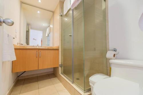 a bathroom with a glass shower and a toilet at Savanna Suite Rep Salvador in Quito