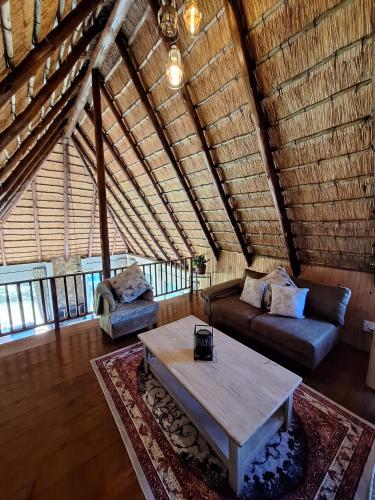 a living room with a couch and a coffee table at Lakeview Cottage, Curry's Post - SOLAR POWERED in Howick