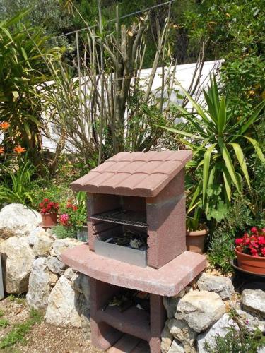 a brick bird house sitting on a pile of rocks at B&b La Casa Del Sole in Borgaria