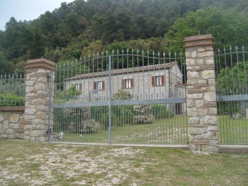 a gate in front of a building with a fence at B&b La Casa Del Sole in Borgaria