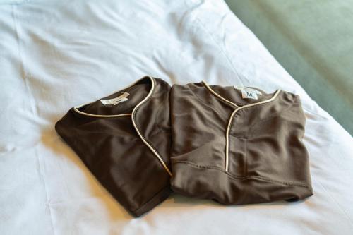 a pair of brown pants sitting on a bed at HOTEL FARO manazuru - Vacation STAY 56476v in Manazuru