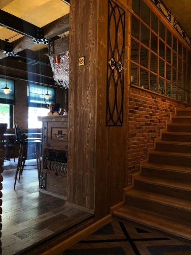 a staircase in a restaurant with a brick wall at VinoOdor - ვინოოდორ in Tʼelavi