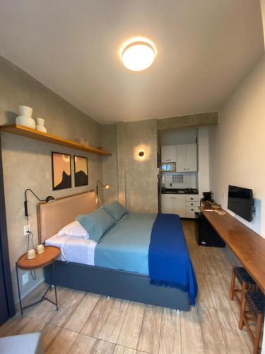1 dormitorio con cama, escritorio y cocina en Copa Hype Studio, en Río de Janeiro