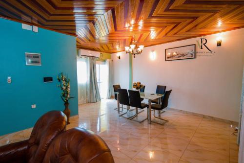 a dining room with a table and chairs at Résidence Vinelly in Douala