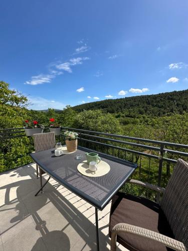 a table and chairs on a balcony with a view at Gold Apartments in Skradin