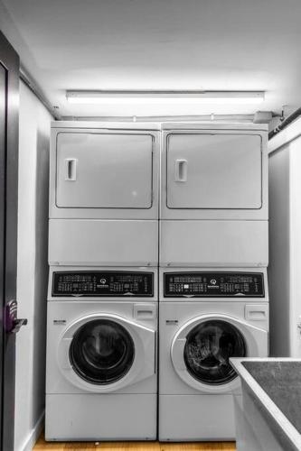 four washers and dryers stacked on top of each other in a kitchen at DTWN Historic Hotel, The Phenix, Ground Floor, Room # 100 in Bangor